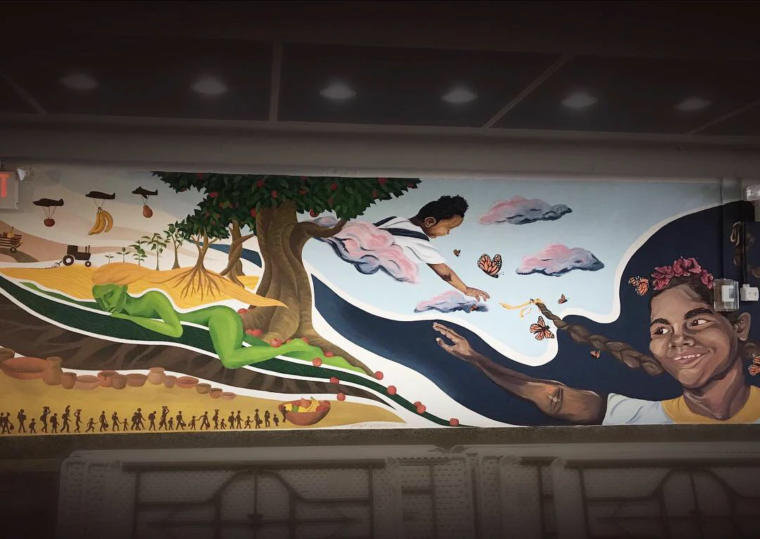 Pachamama mural detail with agricultural and earth motifs.